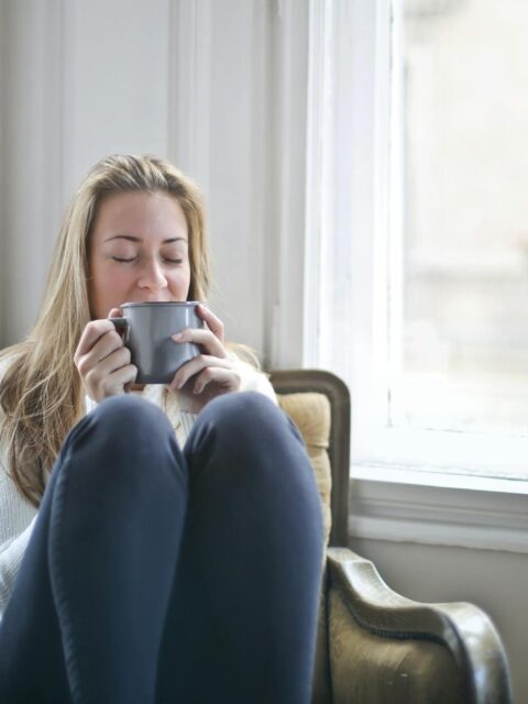 Woman Holding Gray Ceramic Mug